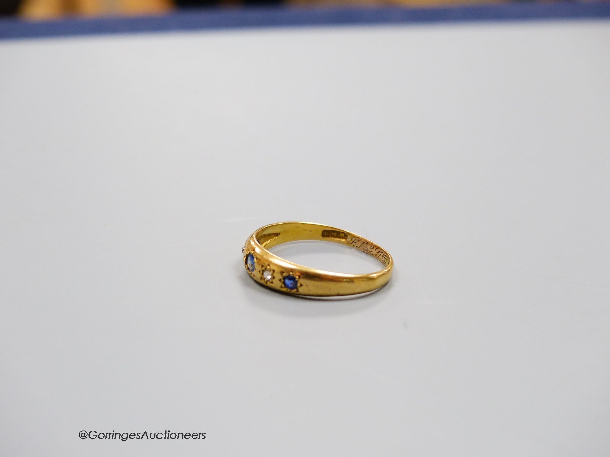 An 18ct gold sapphire and diamond 5-stone ring, size R, gross 2g.